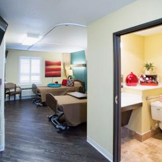 A modern interior showcasing a cozy living room connected to a well-appointed bathroom.