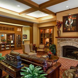 A traditional living room with a wooden interior and a cozy fireplace.