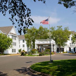 A scenic view of a hotel with an American flag flying in front.