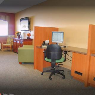 A modern office workspace with desks and computers.