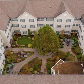 Aerial view of a building with a landscaped courtyard in the center.