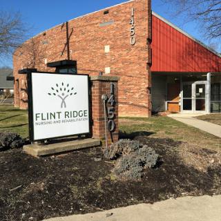 Exterior view of the Flint Ridge building with a prominent sign.