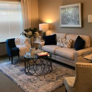 A cozy living room with elegant decor, featuring a comfortable sofa, stylish coffee table, and warm lighting.