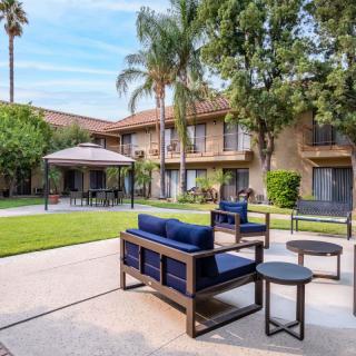 A tranquil courtyard with patio furniture and lush greenery.