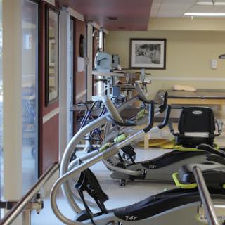 A view of exercise equipment in a rehabilitation gym, designed for physical therapy and fitness.