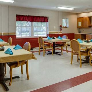 A clean and well-arranged dining room with tables set for service.