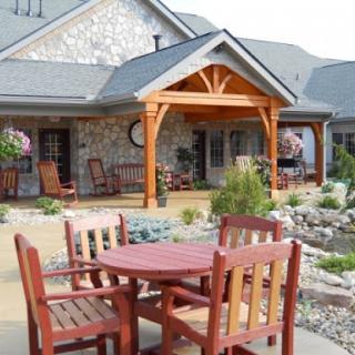 A cozy outdoor seating area next to a beautifully designed house.