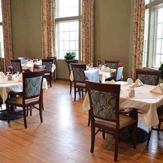Elegant dining room with neatly arranged tables and chairs.