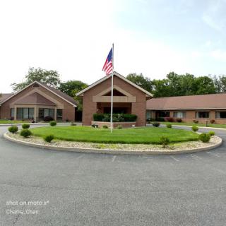 A welcoming community building with an American flag and well-maintained landscaping.