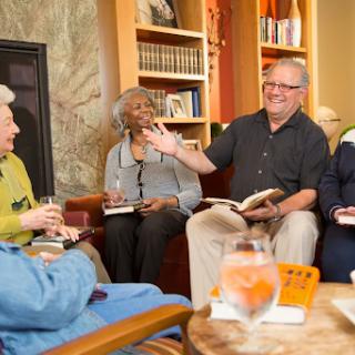 A lively book club meeting where a group of seniors engages in thoughtful discussion.