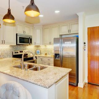 A modern kitchen with stainless steel appliances and granite countertops.