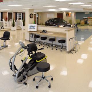 A well-equipped therapy room featuring exercise machines and a welcoming environment.