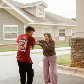 A young person helping an elderly woman, showcasing the beauty of kindness and support in the community.