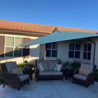 Cozy outdoor patio area with comfortable seating and an umbrella.