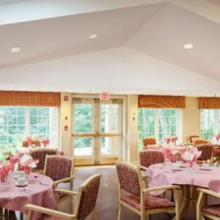 An elegantly decorated dining room with tables set for guests.