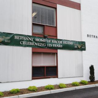 Exterior view of Bethany Home with a banner celebrating 125 years.