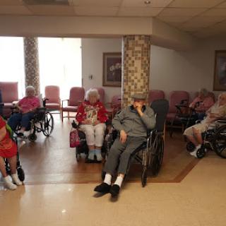 Elderly residents participating in a community gathering at a care home.