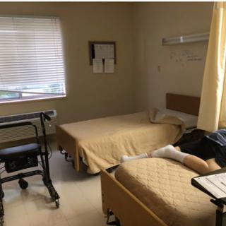 A shared patient room in a healthcare facility, featuring two beds and essential medical equipment.