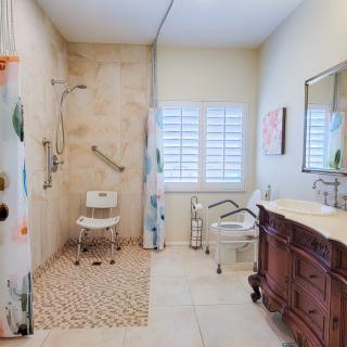 An accessible bathroom with a walk-in shower and supportive features.