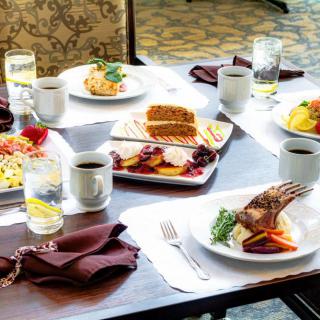 A table set with a variety of meals and drinks, ready for dining.