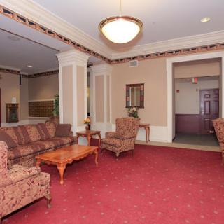 A cozy lobby area featuring comfortable seating and warm decor.