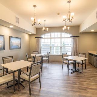 A modern dining area featuring elegant lighting and comfortable seating.