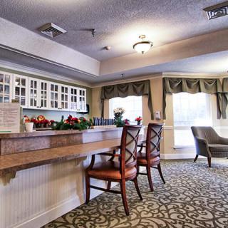 A comfortable and well-lit lobby area with chairs and a desk.