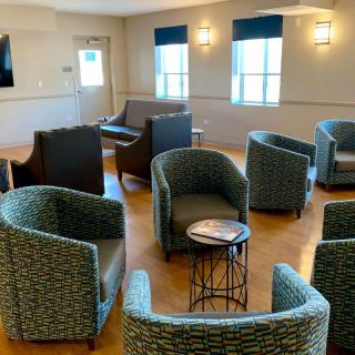 A modern lounge area with comfortable seating and tables.