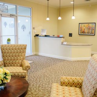 A welcoming waiting area with comfortable seating and a reception desk.