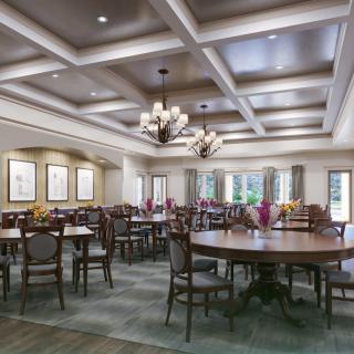 A spacious dining room with elegant lighting and neatly arranged tables and chairs.