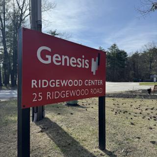 Sign for Genesis at Ridgewood Center, displaying the address.