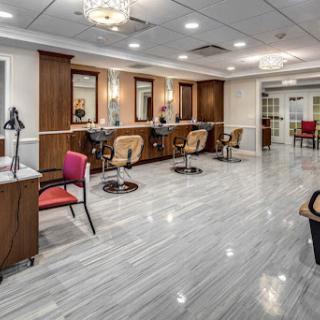 A spacious and modern hair salon featuring elegant decor and comfortable styling stations.