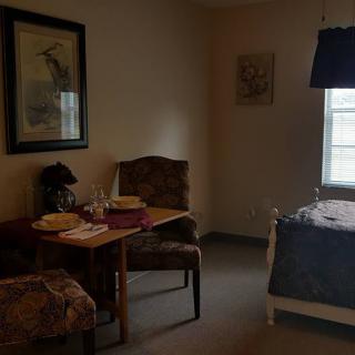 A cozy room with a dining area and a single bed.