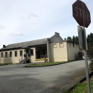 An interesting building with a stop sign in view, situated at a quiet intersection.