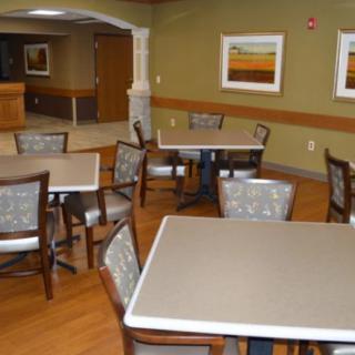 An empty dining area with neatly arranged tables and chairs.
