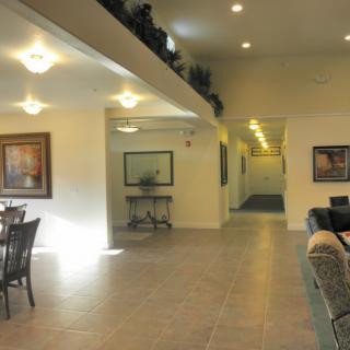 Spacious interior with comfortable seating and artwork on the walls.