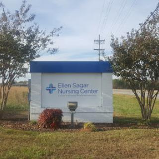 Sign for a nursing center located outdoors, indicating a healthcare facility.