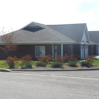 A suburban residential building with landscaped surroundings.