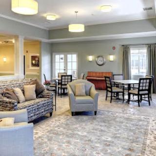 A cozy and inviting lounge area featuring comfortable seating and warm lighting.