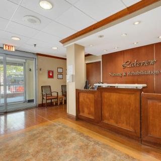 A reception area with a wooden front desk and a waiting area near the entrance.