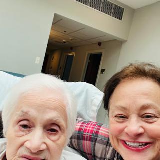 A joyful moment captured between a caregiver and an elderly woman.