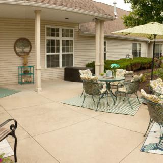A cozy outdoor patio with seating and an umbrella, perfect for relaxation.