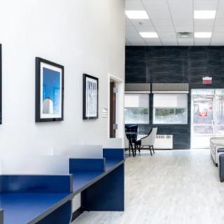 A modern office interior with seating and framed artwork on the walls.