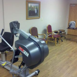 A therapy room with exercise equipment and seating arrangements.