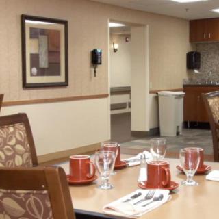 An indoor dining area with neatly arranged table settings, including cups and saucers.