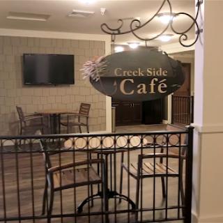 The inviting entrance to the 'Caf' area, featuring a cozy seating arrangement.