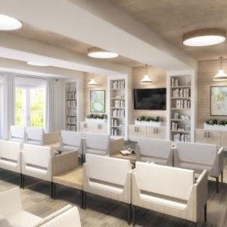 A modern waiting room with neutral tones and comfortable seating.