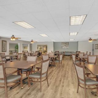 Spacious dining area with multiple tables and chairs, featuring a modern interior design.