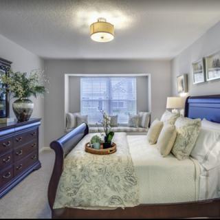 A well-appointed bedroom featuring elegant furniture, soft lighting, and tasteful decor.