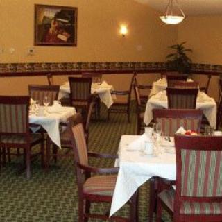 An empty restaurant dining area with neatly arranged tables and chairs.